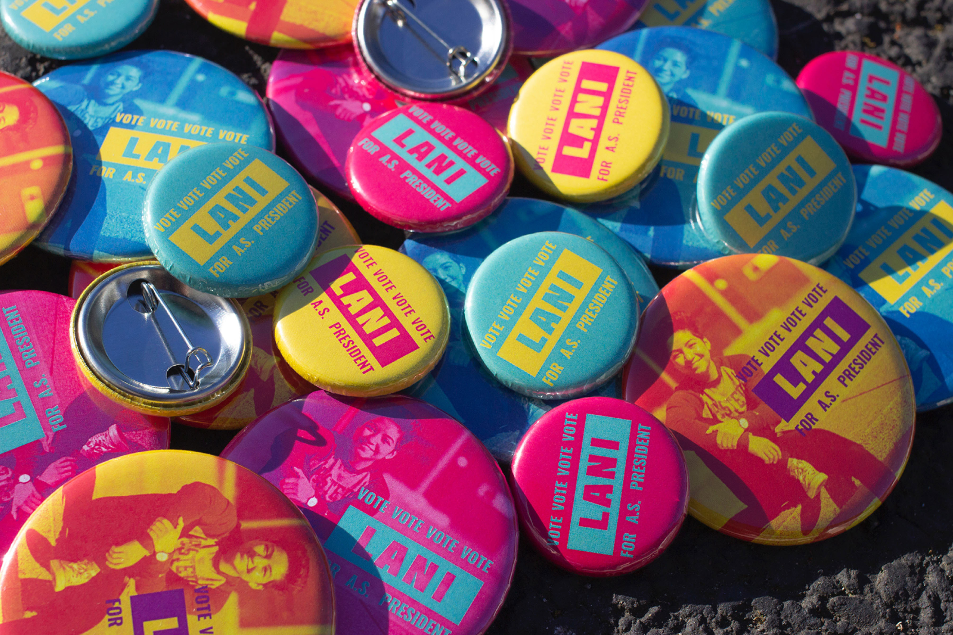 Close up shot of a pile of 'vote Lani' buttons in assorted sizes.